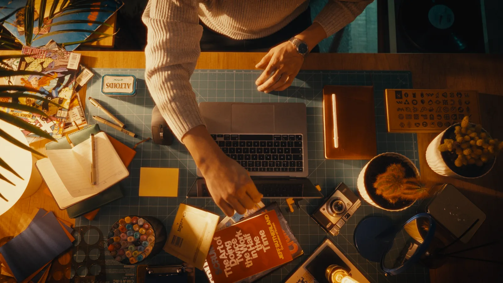 The same studio desk from above with Sam Hox at work