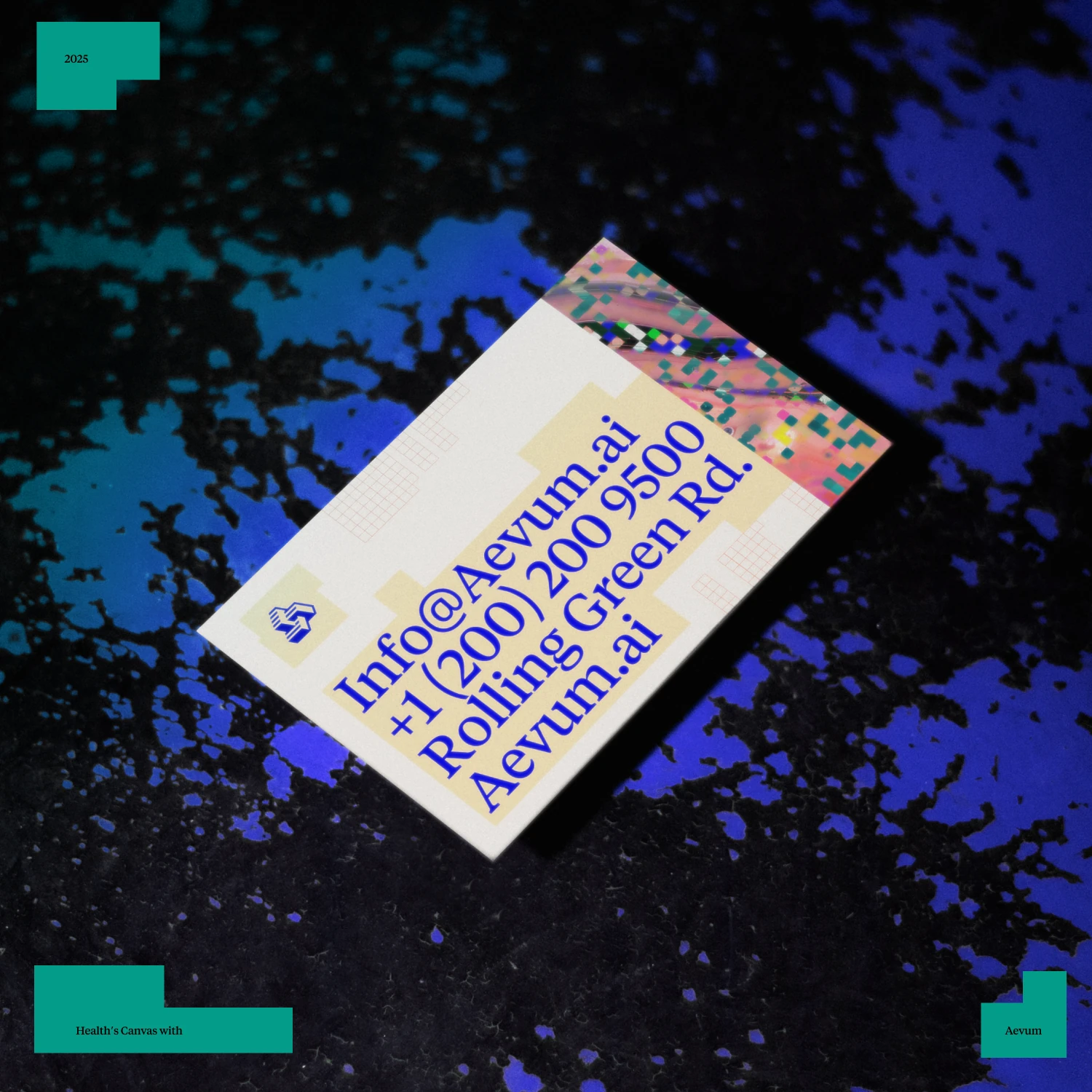 Aevum AI business card with contact details, lying on a blue and black paint texture