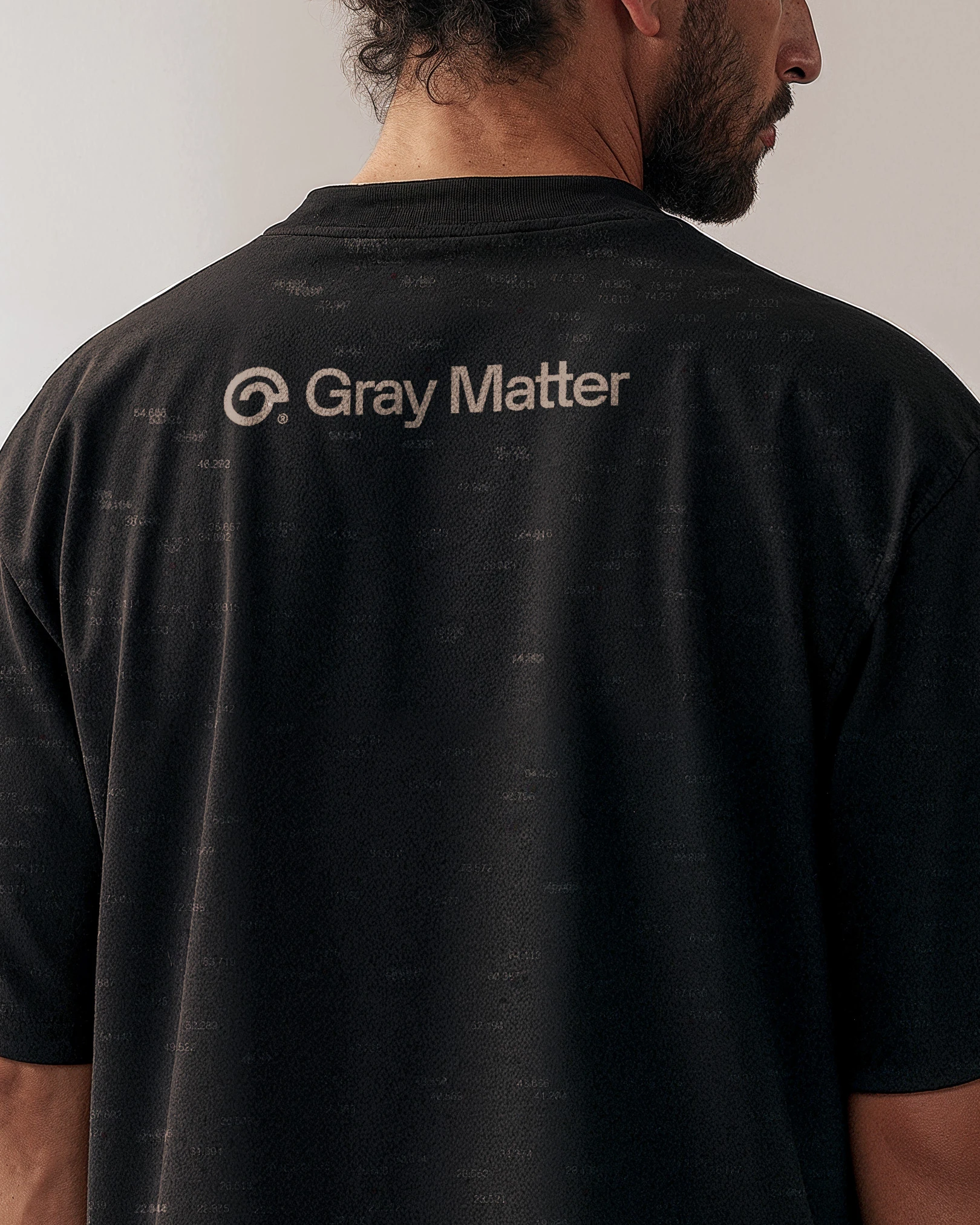 Back of a man in a black Gray Matter t-shirt with the logo in grey