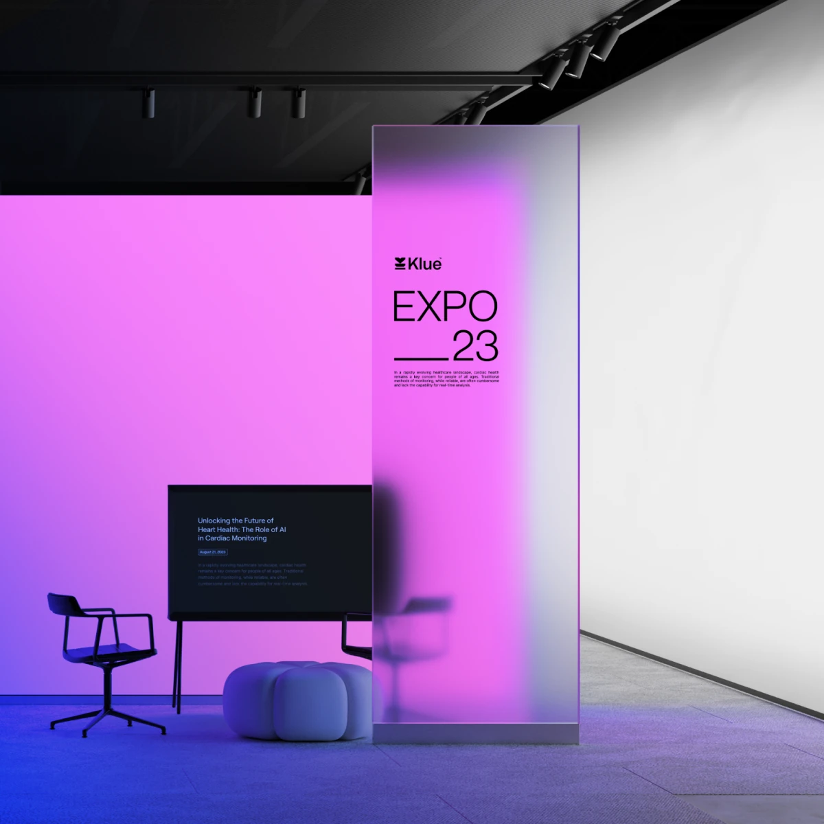 Klue Expo 23 booth with a frosted glass sign, pink lit wall and a screen