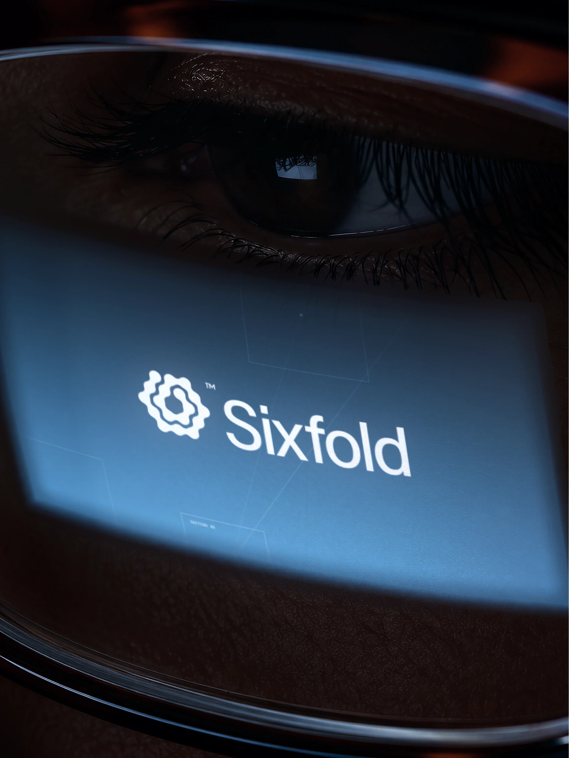 Close-up of an eye with the Sixfold logo glowing on a screen in front of it